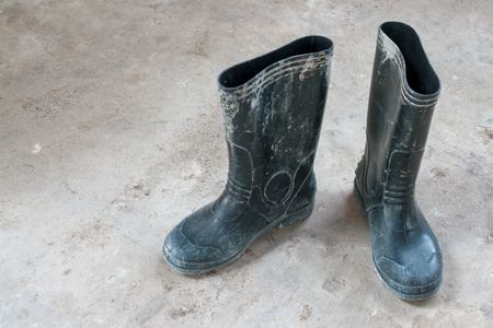 Old boots on the concrete floor.