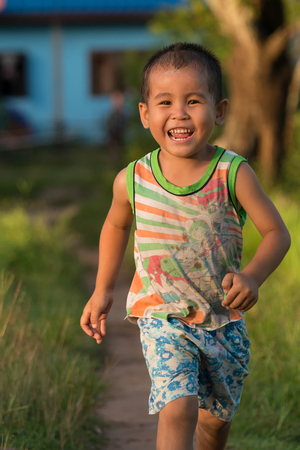 CHAMPASAK, LAOS, SEPTEMBER 23 : Portrait of unidentified Laos little boy are running happily on September 23, 2015のeditorial素材