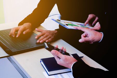 Business people working in the office room and looking to financial reports reading information to boss background texture concept.の写真素材