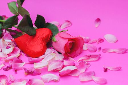 happy Valentine's day on the romantic holiday. the concept of condom,Rose and chocolate heart on pink background.の写真素材