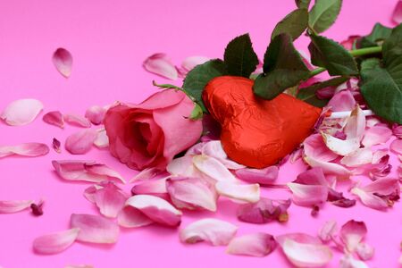 happy Valentines day on the romantic holiday the concept of condomRose and chocolate heart on pink backgroundの写真素材