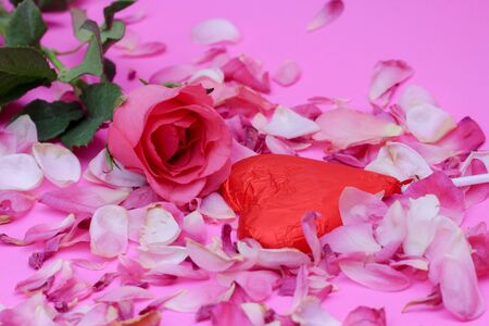 happy Valentines day on the romantic holiday the concept of condomRose and chocolate heart on pink backgroundの写真素材