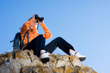 Beautiful young woman on mountain top in autumn