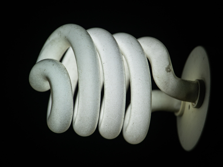 White energy saving bulb with blacked background.