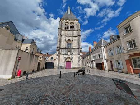 Historic stone bell tower on cobblestone square