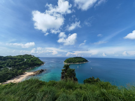Tropical Island with Beach and Blue Sea under Cloudy Skyの写真素材