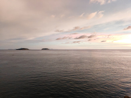 Calm Sea at Sunset with Distant Islands