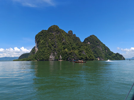 Tropical Island with Green Cliffs in Blue Seaの写真素材
