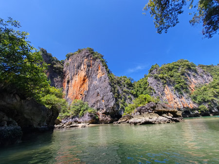Scenic Limestone Cliffs Rising Above Tropical Lagoonの写真素材
