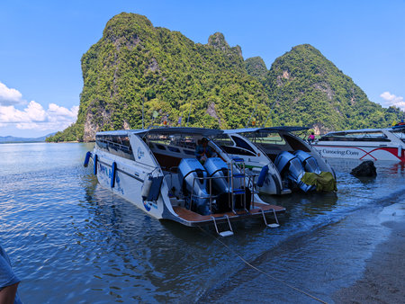 Speedboats Docked by Tropical Island Shoreの写真素材