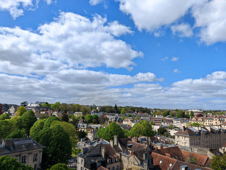 Town view with rooftops and trees under blue sky