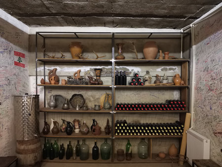 Wine cellar shelves with pottery and bottles