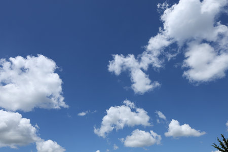 Soft cumulus clouds in blue summer sky