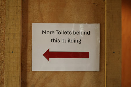 Toilet direction sign on wooden wallの写真素材