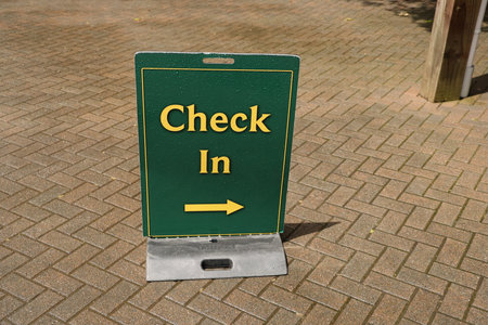 Check in sign on paved pathの写真素材