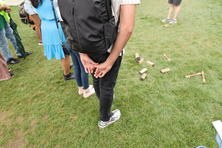 Young adults standing near lawn gameの写真素材