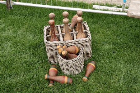 Vintage wooden skittles in baskets on grassの写真素材