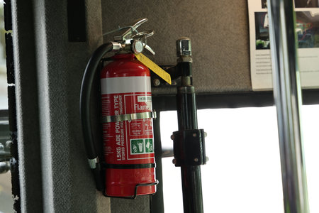 Red Fire Extinguisher Inside Passenger Bus