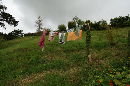 Clothes Drying On Hillside Line Under Cloudy Skyの写真素材