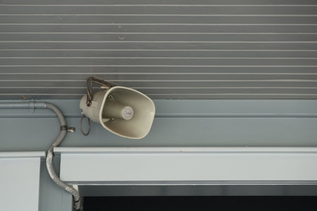 Ceiling Mounted Outdoor Loudspeaker Beside Metal Conduit