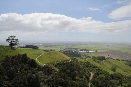 Rolling Hillside Valley Panorama Under Bright Clouds