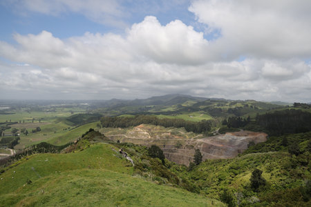 Rolling Hillside Quarry Beneath Expansive Cloudy Skyの写真素材