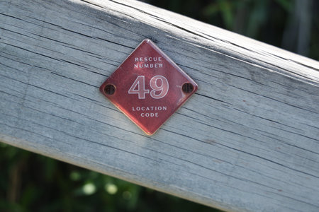 Red Diamond Sign Mounted Weathered Wooden Rail