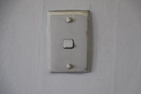 Old White Wall Light Switch Plate Closeupの写真素材