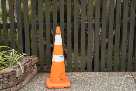 Orange Traffic Cone Beside Garden Brick Planter