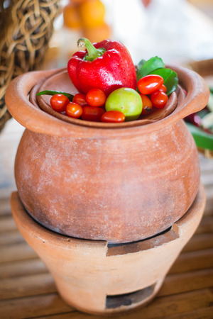 Fresh vegetables on the plate on the loam plateの写真素材