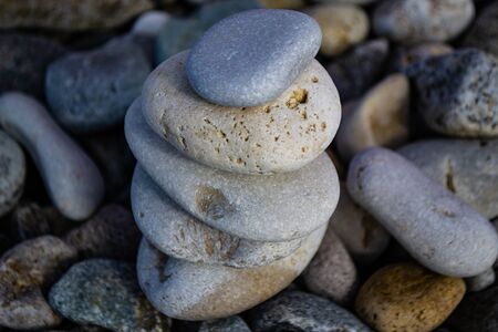 stones stacked pyramid on the beach against blue sky and sea.の写真素材
