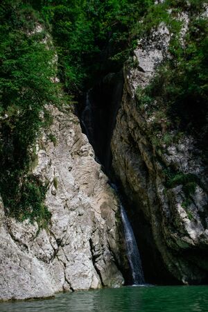 Small waterfall from the rock cliff in the national park.の写真素材