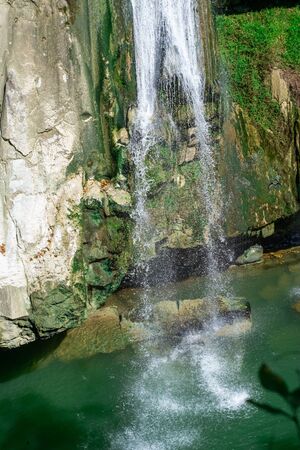 Small waterfall from the rock cliff in the national park.の写真素材
