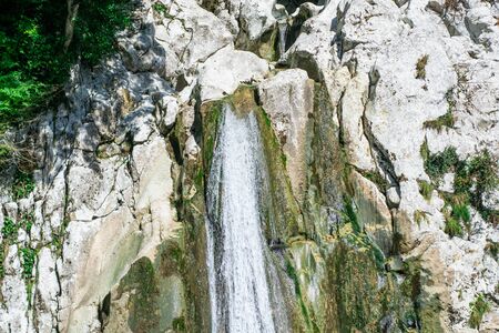 Small waterfall from the rock cliff in the national park.の写真素材