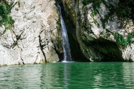 Small waterfall from the rock cliff in the national park.の写真素材