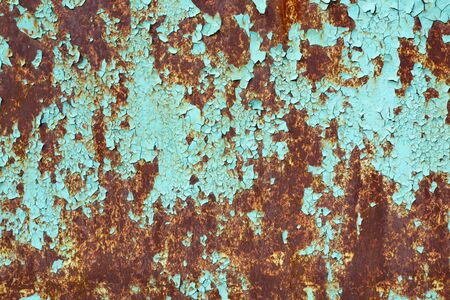 Rusty surface of metal plate with blue cracked color paint. Rust on old colored metal. Old blue...