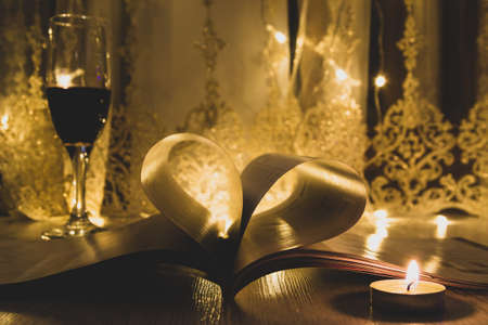 Valentine day. Book with pages in heart shape. Dark background.の写真素材