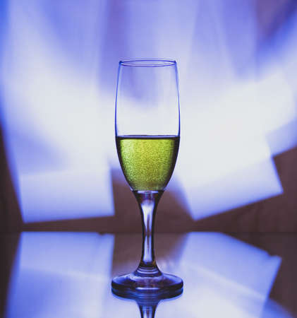 glass glass with champagne on a multicolored background