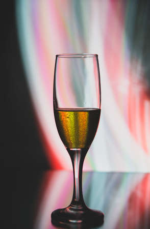 glass glass with champagne on a multicolored backgroundの写真素材