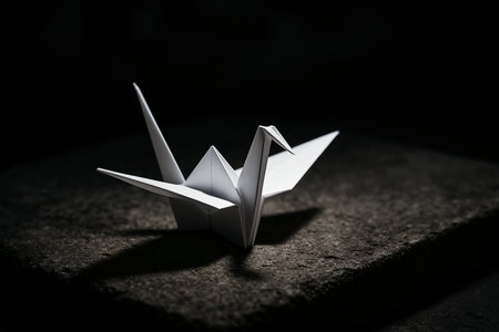 Paper origami crane on dark background. Creative artwork decoration. Selective focusの素材