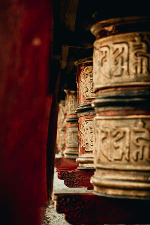 Closeup of Prayer Wheels in Shey Monastery in Ladakh, India. It is believed that each turn of a prayer wheel represents a recitation of the prayer inside and transports it to heaven.の写真素材