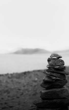 stack of stones near a lakeの写真素材