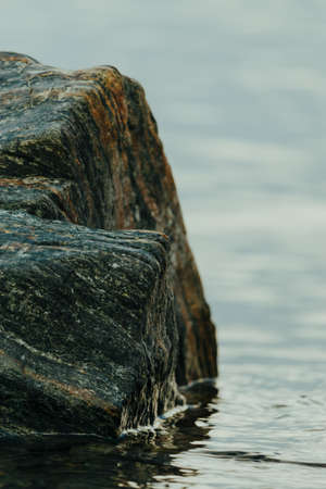 a rock boulder in the water closeupの写真素材