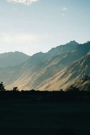sunset in Nubra Valley, Ladakh, India against sand dunes and mountainsの写真素材