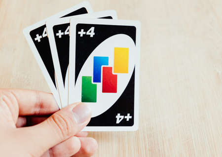 hand holding 3 uno draw 4 cardsのeditorial素材