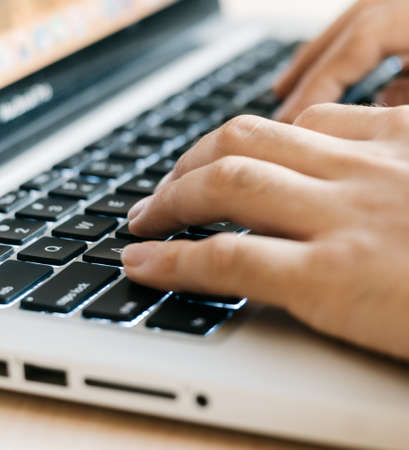 hands typing on a keyboardの写真素材