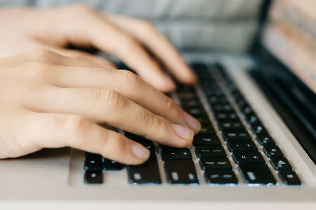hands typing on a keyboardの写真素材