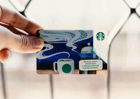A person holding a Starbucks card.のeditorial素材