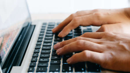 hands typing on a keyboardの写真素材