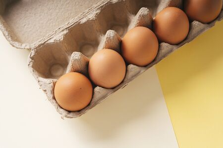 Organic chicken brown egg in paper box carton. Healthy fresh food from farm.の写真素材